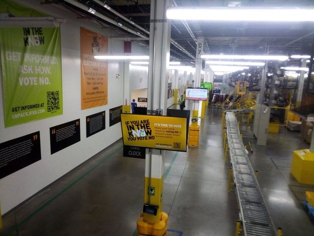 A photo of signs Amazon has hung around the plant encouraging workers to reject the union.